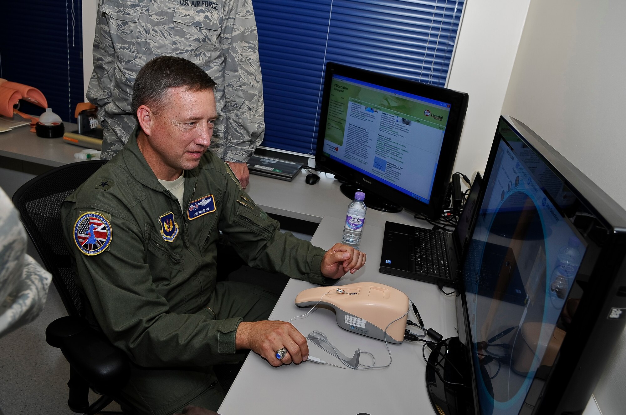 ROYAL AIR FORCE LAKENHEATH, England -- Brig. Gen. Jon Norman, Director, United States Air Forces in Europe-United Kingdom, learns how to insert a needle into a simulated arm at the 48th Medical Group Simulator Center Aug. 9, 2012. Norman toured the 48th Maintenance Group, 48th Medical Group and various locations around RAF Lakenheath.  (U.S. Air Force photo by Senior Airman Connor Estes)