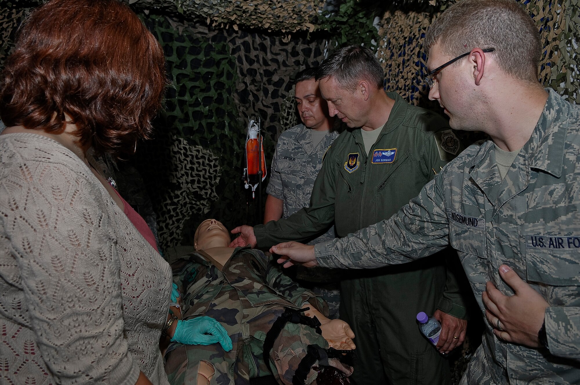 ROYAL AIR FORCE LAKENHEATH, England -- Brig. Gen. Jon Norman (middle), Director, United States Air Forces in Europe-United Kingdom, feels for a simulated heart-beat on a mannequin at the 48th Medical Group Simulator Center Aug. 9, 2012. Norman toured the 48th Maintenance Group, 48th Medical Group and various locations around RAF Lakenheath.  (U.S. Air Force photo by Senior Airman Connor Estes)