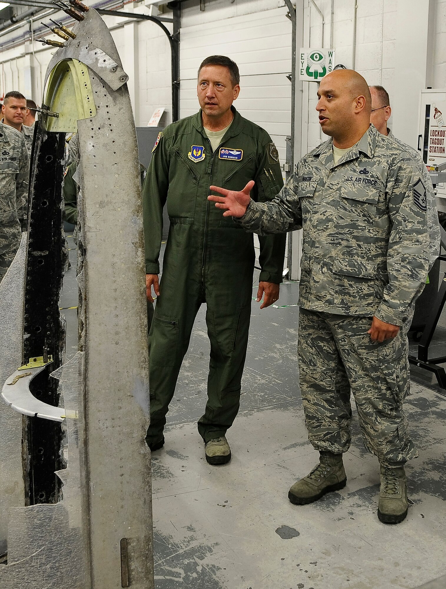 ROYAL AIR FORCE LAKENHEATH, England -- Master Sgt. Duane Nastav, 48th Equipment Maintenance Squadron assistant fabrication flight chief, show Brig. Gen. Jon Norman, Director, United States Air Forces in Europe-United Kingdom, a canopy from a P-51 Mustang aircraft that is being reconditioned, during his visit of the 48th Fighter Wing Aug. 9, 2012. Norman toured the 48th Maintenance Group, 48th Medical Group and various locations around RAF Lakenheath.  (U.S. Air Force photo by Senior Airman Connor Estes)