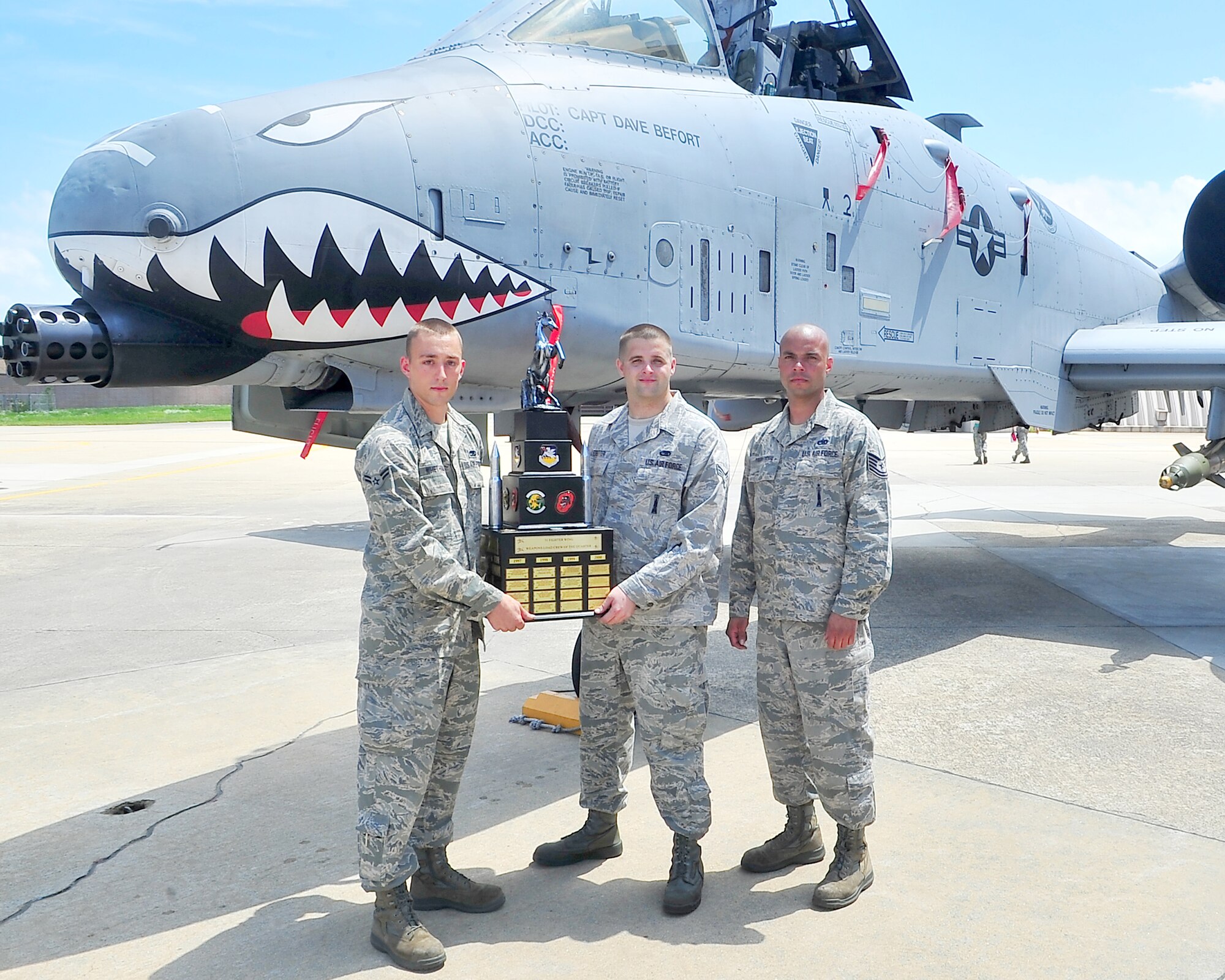 Tech. Sgt. Javier Figueroa-Achevere, Senior Airman Brannon Ledbetter, and Airman 1st Class Kyle Whetam display their recently won weapons load competition trophy at Osan Air Base, Republic of Korea, Aug. 3, 2012. The 75th Expeditionary Fighter Squadron won the competition, securing the coveted trophy. The 75th EFS is on a six-month deployment to Korea from Moody Air Force Base, Ga. (U.S. Air Force photo/Tech. Sgt Raymond Mills)