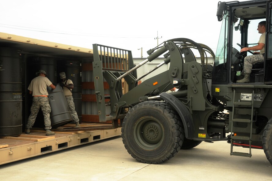 Airman 1st Class Michael Bell, 8th Maintenance Squadron, left, and Staff Sgt. James Dixon, 8th MXS, move a barrel of munitions into a shipping container at Kunsan Air Base, Republic of Korea, Aug. 2, 2012. The munitions will be sent back to the United States to be refurbished; some are inert and from the Korean War. (U.S. Air Force photo/Senior Airman Marcus Morris)