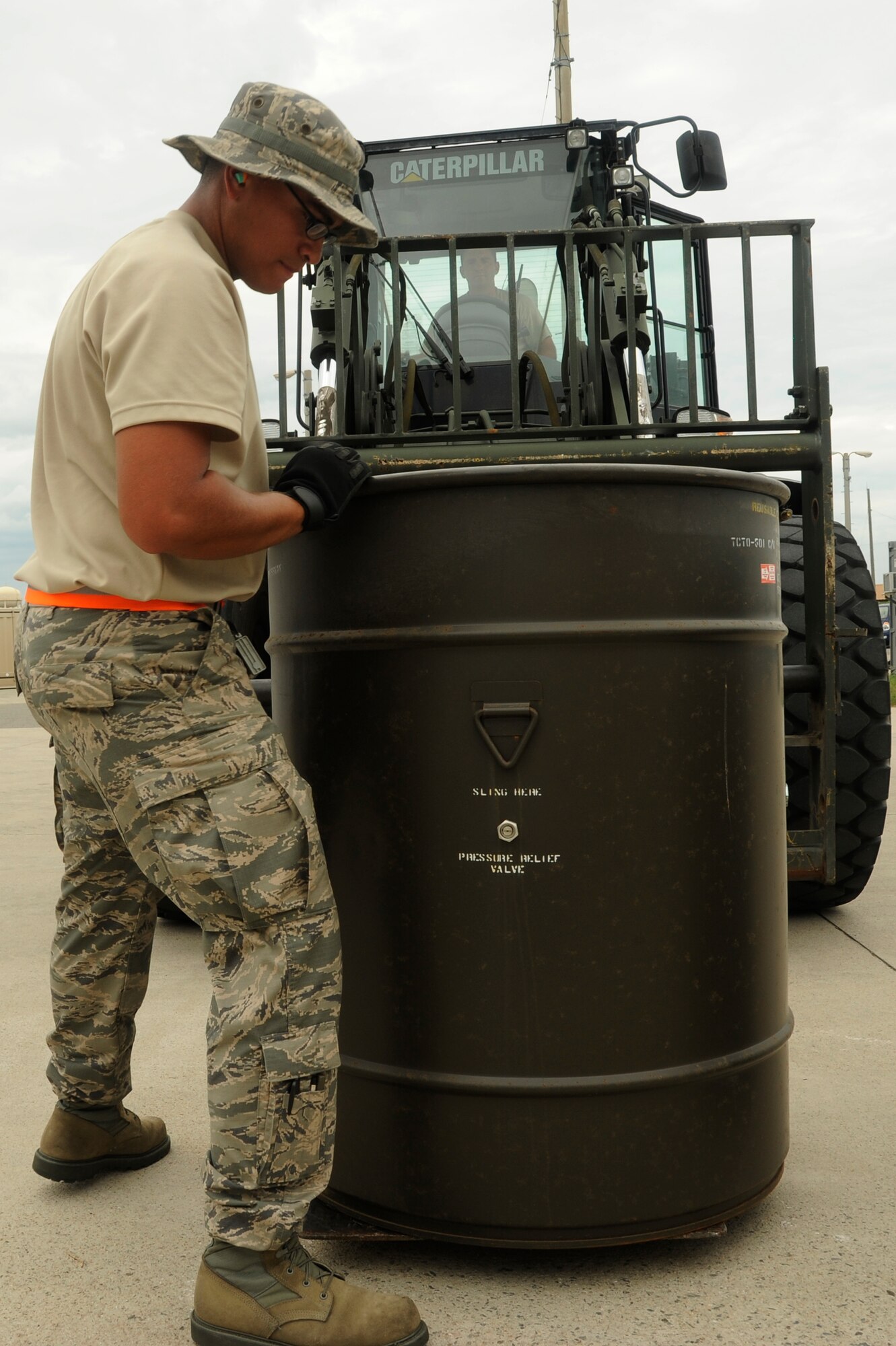 Airman 1st Class Jean Ramos, 8th Maintenance Squadron, loads a barrel of munitions onto a forklift so it can be placed into storage on Kunsan Air Base, Republic of Korea, Aug. 02, 2012. The munitions are being shipped back to the United States to be refurbished for use as back-up munitions. (U.S. Air Force photo/Senior Airman Marcus Morris)