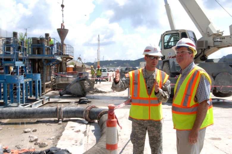 JAMESTOWN, Ky. — Lt. Col. James A. DeLapp, U.S. Army Corps of Engineers Nashville District commander, leads Nashville Mayor Karl Dean on a tour of the work platform at Wolf Creek Dam Aug. 7, 2012 where construction is ongoing to install a barrier wall through the embankment deep into bedrock below the foundation. 