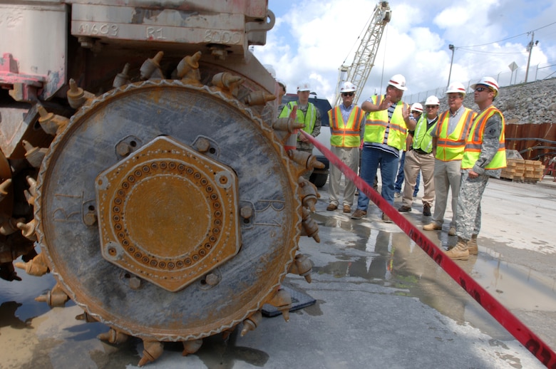 JAMESTOWN, Ky. — A tour group with Nashville Mayor Karl Dean looks at a hydromill on the work platform at Wolf Creek Dam in Jamestown, Ky., Aug. 7, 2012. The U.S. Army Corps of Engineers Nashville District is installing a barrier wall through the dam's embankment into the hard bedrock to stop seepage through the karst geology. 