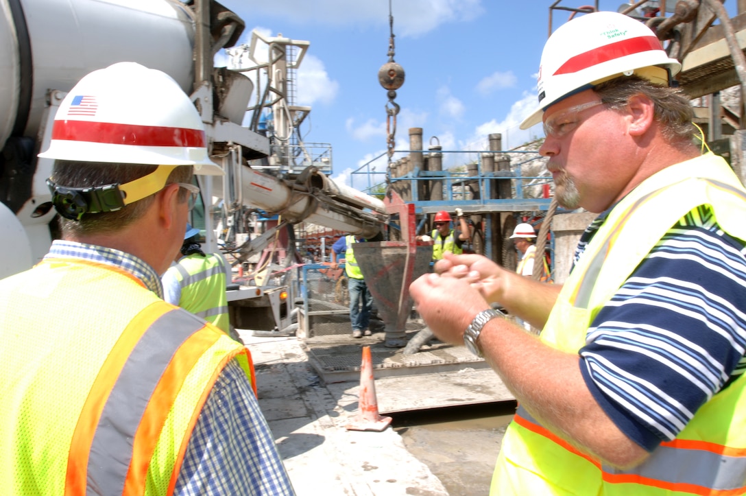 JAMESTOWN, Ky. — Bill DeBruyn (right), U.S. Army Corps of Engineers Nashville District resident engineer for the Wolf Creek Dam Foundation Remediation Project, explains the process of installing a barrier wall into the foundation of the embankment during a tour on the work platform Aug. 7, 2012.