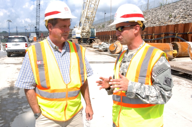 JAMESTOWN, Ky. — Lt. Col. James A. DeLapp, U.S. Army Corps of Engineers Nashville District commander, guides Nashville Mayor Karl Dean on the work platform at Wolf Creek Dam Aug. 7, 2012 where a barrier wall is being installed to stop seepage through the karst geology in the embankment foundation.