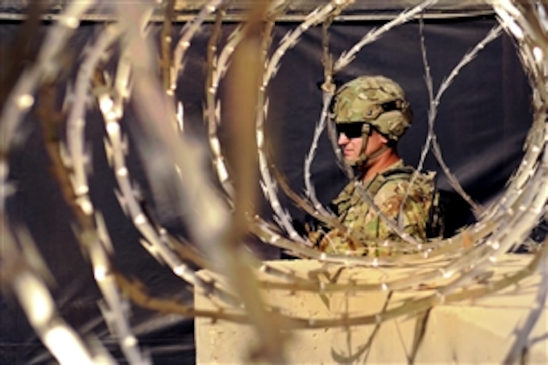 U.S. Navy Petty Officer 2nd Class Andrew Bauman leaves Camp Nathan Smith on a dismounted patrol to survey equipment at a public works facility in Afghanistan's Kandahar province, Aug. 8, 2012. Bauman is assigned to the Kandahar Provincial Reconstruction Team, which includes  troops and civilians deployed to the province to help rebuild and stabilize the local government and infrastructure.