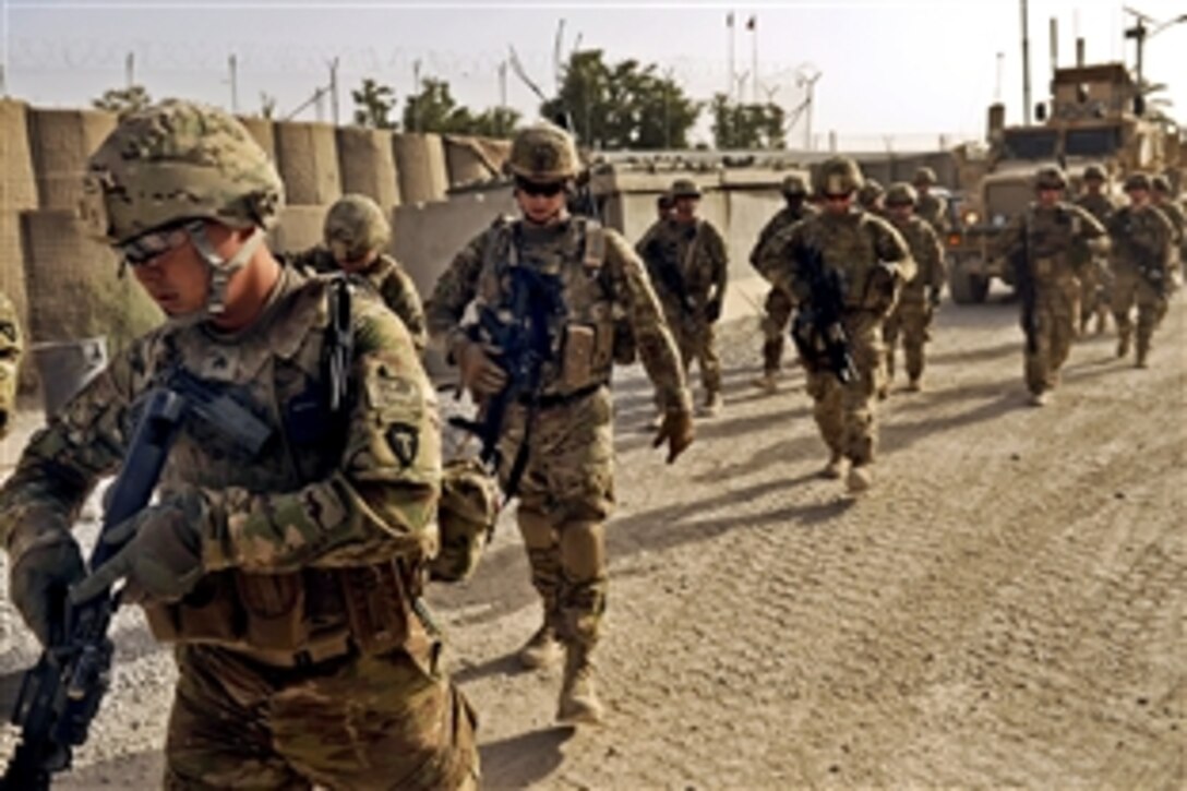 U.S. troops leave Camp Nathan Smith on a dismounted patrol to survey equipment at a public works facility in Afghanistan's Kandahar province, Aug. 8, 2012. The troops are assigned to the Kandahar Provincial Reconstruction Team.