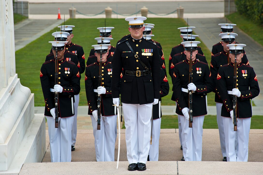 Marine Barracks Washington ceremonial marchers salute the joint forces color guard during a wreath laying ceremony honoring Gen. Harald Sunde, Norway chief of defense, at the Tomb of the Unknown Soldier in Arlington, Va., Aug. 13.