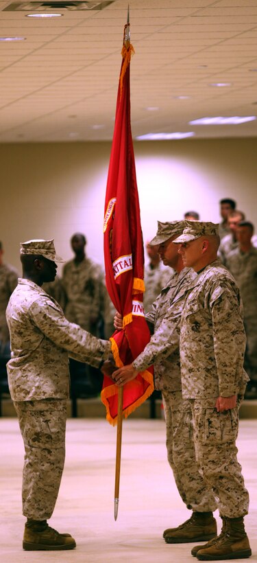 Sgt. Maj. Clive O’Connor, Marine Combat Training Battalion sergeant major, hands the unit guidon to Maj. Carl A. Havens, who will hand it to Lt. Col. Billy R. Moore, signifying the official change of command during the battalion’s Assumption of Command ceremony aboard Camp Geiger Aug. 10. Havens relinquished command of MCTBn to Moore and is going to be the battalion executive officer.