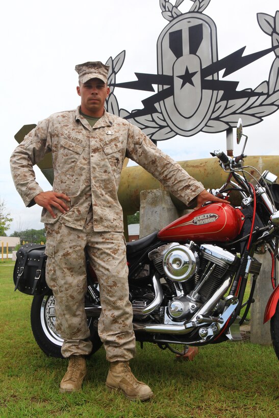 Staff Sgt. Christopher P. Lukas, an explosive ordnance disposal team leader with 2nd EOD Company, 2nd Marine Logistics Group, who won the 2012 EOD Technician of the Year award, stands before his two great passions of motorcycles and the EOD insignia for his unit aboard Camp Lejeune, N.C., Aug. 10, 2012. He credits the mentorship of his leaders in the EOD field for his success with the award, which recognizes only one Marine each year.