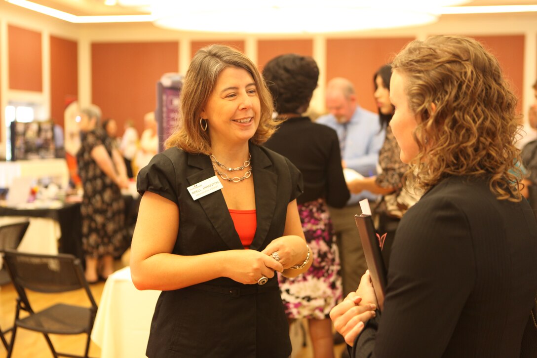 A military spouse speaks to a potential employer at the Marston Pavilion aboard Marine Corps Base Camp Lejeune during the Military Spouse Business Alliance Hiring Fair and Career Forum Aug. 9. There were approximately 30 employers for the more than 400 job-seekers present. 