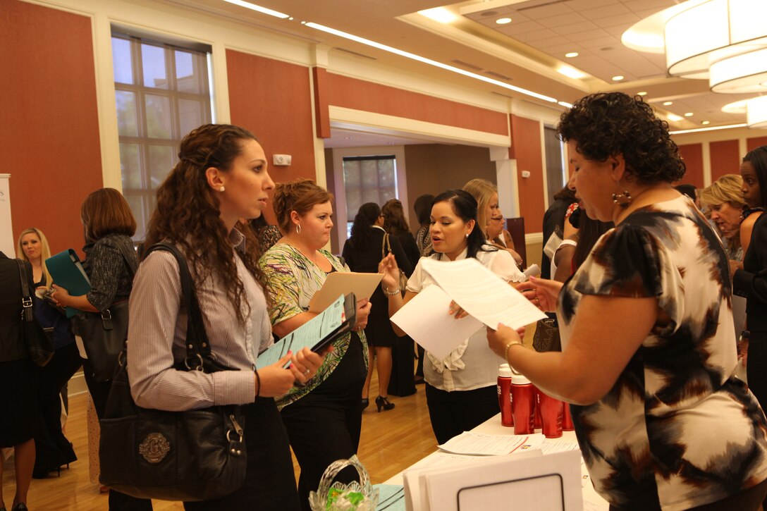 A military spouse speaks to a potential employer at the Marston Pavilion aboard Marine Corps Base Camp Lejeune during the Military Spouse Business Alliance Hiring Fair and Career Forum Aug. 9. There were approximately 30 employers for the more than 400 job-seekers present. 
