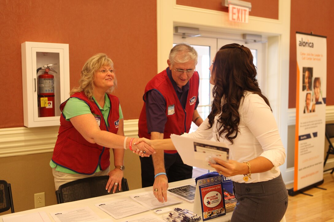 A military spouse speaks to a potential employer at the Marston Pavilion aboard Marine Corps Base Camp Lejeune during the Military Spouse Business Alliance Hiring Fair and Career Forum Aug. 9. There were approximately 30 employers for the more than 400 job-seekers present. 