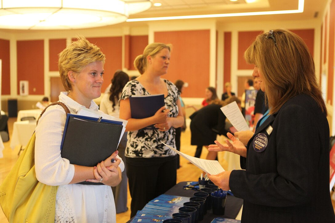 A military spouse speaks to a potential employer at the Marston Pavilion aboard Marine Corps Base Camp Lejeune during the Military Spouse Business Alliance Hiring Fair and Career Forum Aug. 9. There were approximately 30 employers for the more than 400 job-seekers present. 