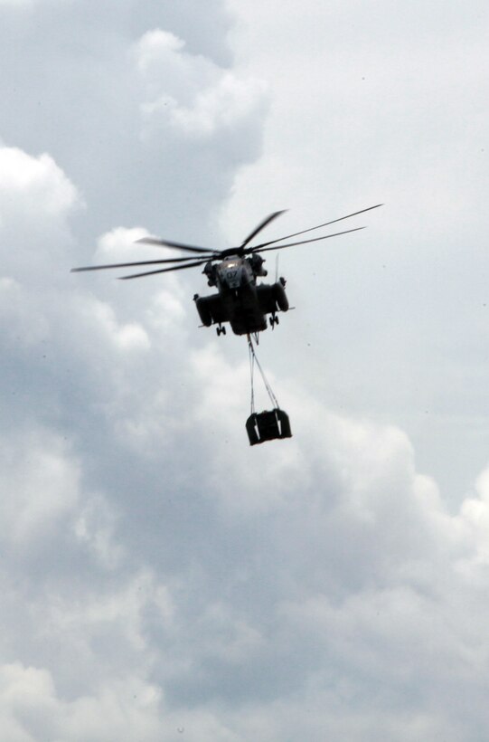A CH-53E Super Stallion with Marine Heavy Helicopter Squadron 366, 2nd Marine Aircraft Wing prepares to drop a section of an improved ribbon bridge during a training exercise with 8th Enginner Support Battalion, 2nd Marine Logistics Group aboard Camp Lejeune, N.C., Aug. 8, 2012. The training made history. It marked the first time in 10 years that Bridge Company, 8th ESB collaborated with elements of 2nd MAW to open and construct a collapsable raft while already in water. (Photo by Pvt. Franklin E. Mercado)