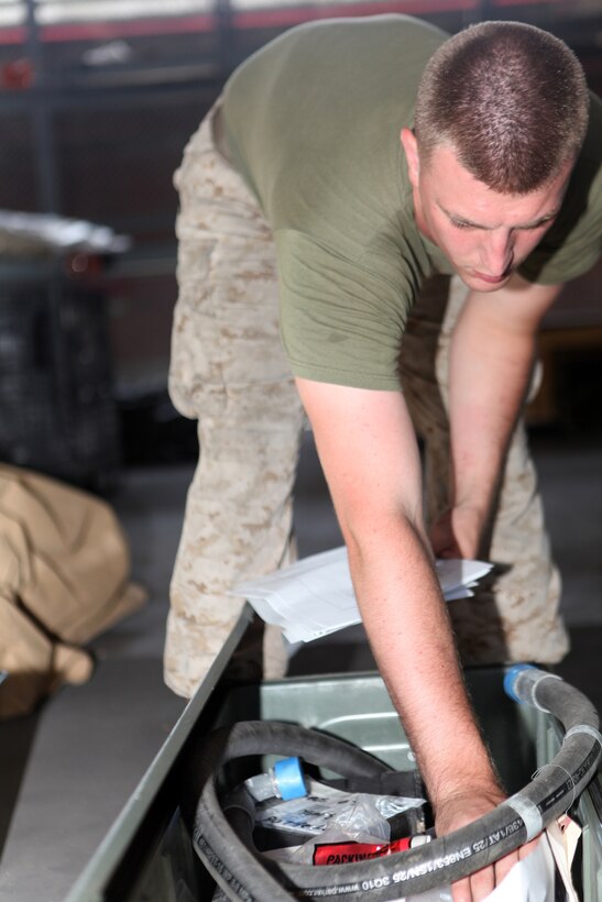 Cpl. Jonathon C. Head, a supply clerk with Combat Logistics Battalion 22, 2nd Marine Logistics Group, digs through a container looking for each item on the gear list during an inventory of the warehouse on Camp Lejeune, N.C., Aug. 9, 2012.  Head is responsible for inventorying the gear, storing it, and ensuring it is ready for deployment.  (U.S. Marine Corps photo by Sgt. Rachael K. A. Moore)