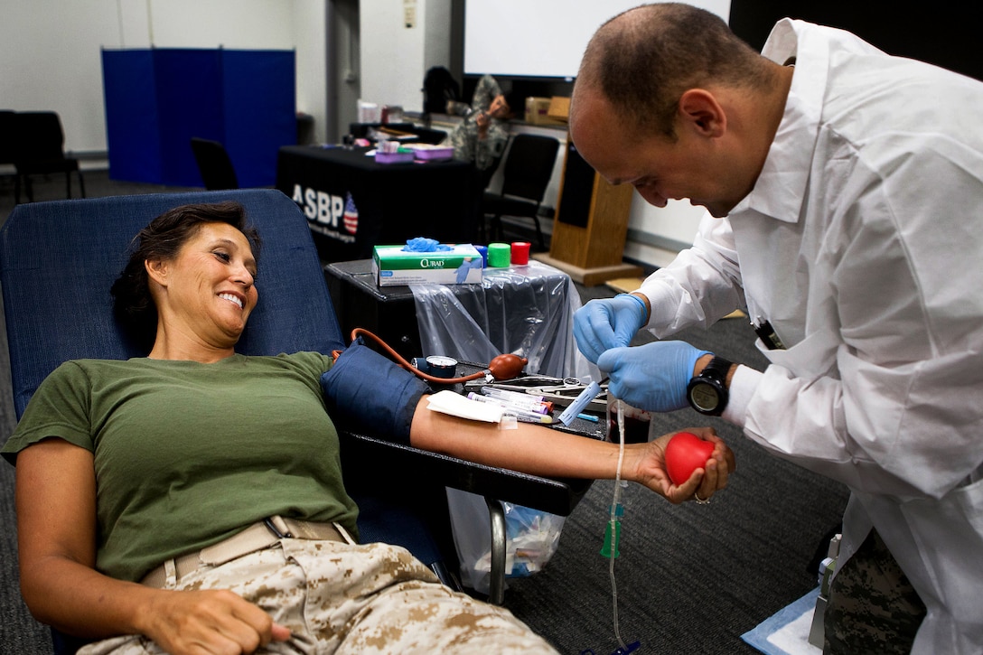 Col. Annita M. Best, reserve public affairs director for U.S. Marine Corps Forces, Pacific, participates in a blood drive hosted by the Armed Services Blood Program in the Pollock Theater here Aug. 9. ASBP has reached 50 percent of its goal to collect 500 pints of blood in August 2012. Although the program is located at Tripler Army Medical Center in Honolulu, they frequently visit military installations throughout Oahu to make donating more convenient for service members. 