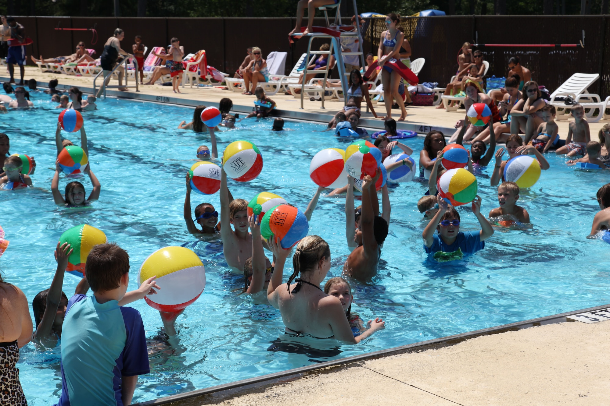 SHAW AIR FORCE BASE, S.C. – Children play with beach balls in the pool during the Summer Splash event at Woodland Pool on Shaw Air Force Base, S.C., Aug. 13, 2012. SAFE Credit Union donated 25 beach balls for the event. More than 1,200 members of Team Shaw participated in the event that was sponsored by the city of Sumter, S.C., Farmer's Telephone Cooperative, Progress Energy and 20th Fighter Wing members.  Attendees were treated to free food, face painting, water games, music and snow cones. (U.S.  Air Force photo by 1Lt. Ann K. Blodzinski/Released)
