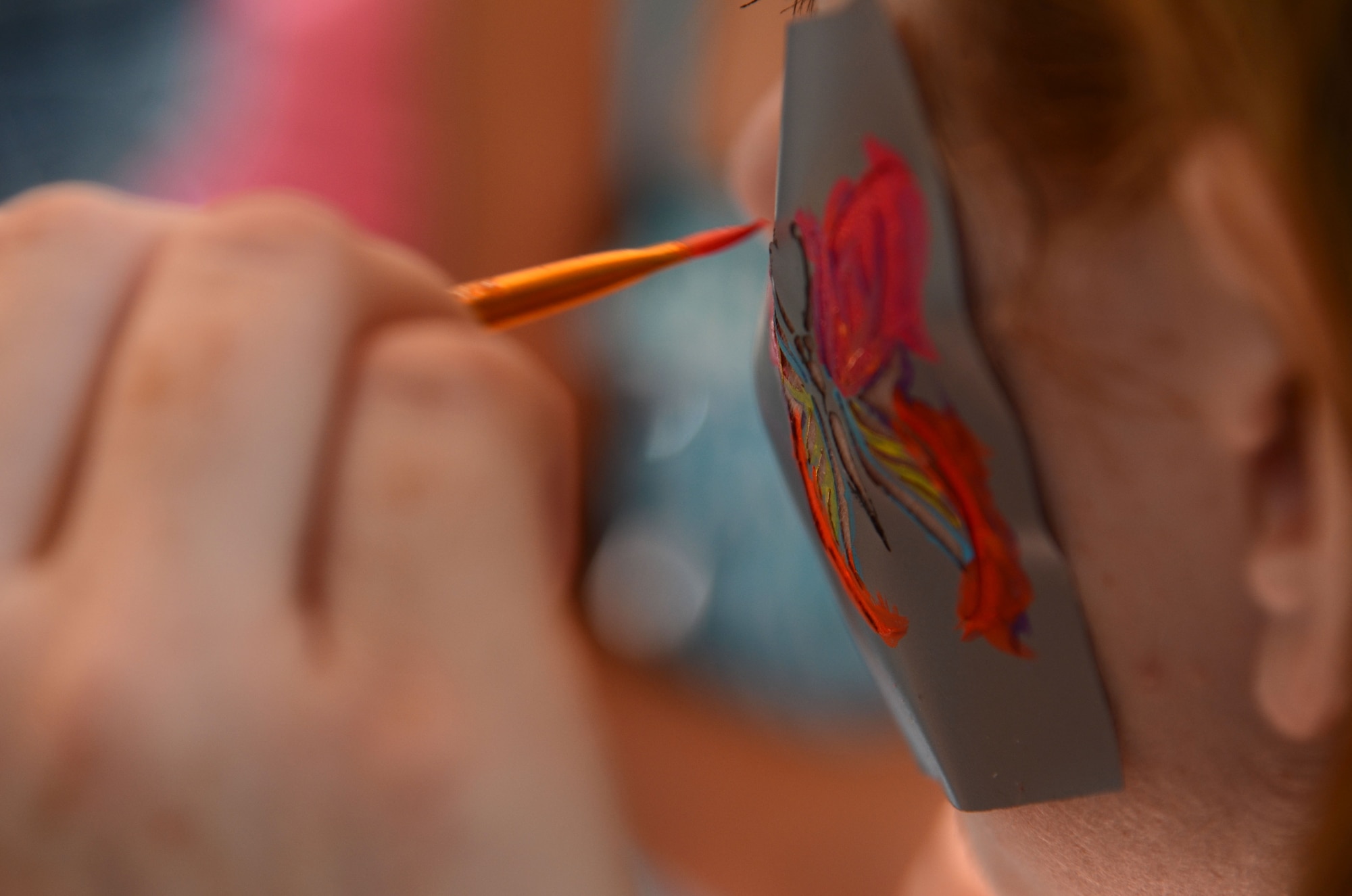SHAW AIR FORCE BASE, S.C. – A child has a butterfly painted on her during the Summer Splash event held outside of the Woodland Pool on Shaw Air Force Base, S.C., Aug. 13, 2012. More than 1,200 members of Team Shaw participated in the event that was sponsored by the city of Sumter, S.C., Farmer's Telephone Cooperative, Progress Energy and 20th Fighter Wing members.  Attendees were treated to free food, face painting, water games, music and snow cones. (U.S.  Air Force photo by Master Sgt. Cohen A. Young/Released)