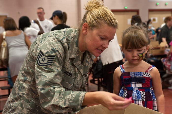 Tech. Sgt. Rebecca Palmer, 152nd Airlift Wing public affairs specialist, Nevada Air National Guard, gathers school supplies with her daughter, Alanah Palmer, 3, during the Operation Homefront's Backpacks for Back to School event Aug. 11, 2012, in Las Vegas, Nev. 1,300 backpacks were handed out state wide during the event. (U.S. Air Force photo by Staff Sgt. Christopher Hubenthal)