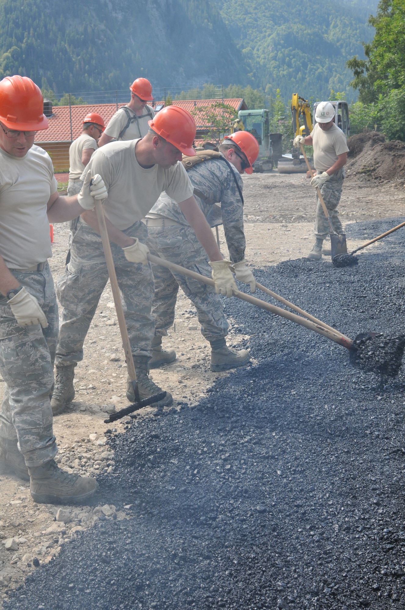 Members of the Wyoming Air National Guard’s 153rd Civil Engineer Squadron lay asphalt Aug. 13, 2012, at the NATO School recreation center, Oberammergau, Germany. Airmen from the 153rd CES are putting their skills to work as they conduct their annual training. (U.S. Air Force photo by Staff Sgt. Natalie Stanley)