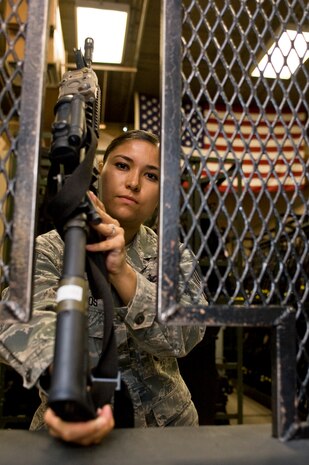 Staff Sgt. Adela Avalos, 99th Security Forces Squadron non-commissioned officer in charge of the armory, issues an M4 carbine rifle Aug. 13, 2012, at Nellis Air Force Base, Nev. The armory staff is responsible for over 100 weapons, ammunition, and equipment that supports the security and safety of Nellis AFB. (U.S. Air Force photo by Airman 1st Class Christopher Tam)