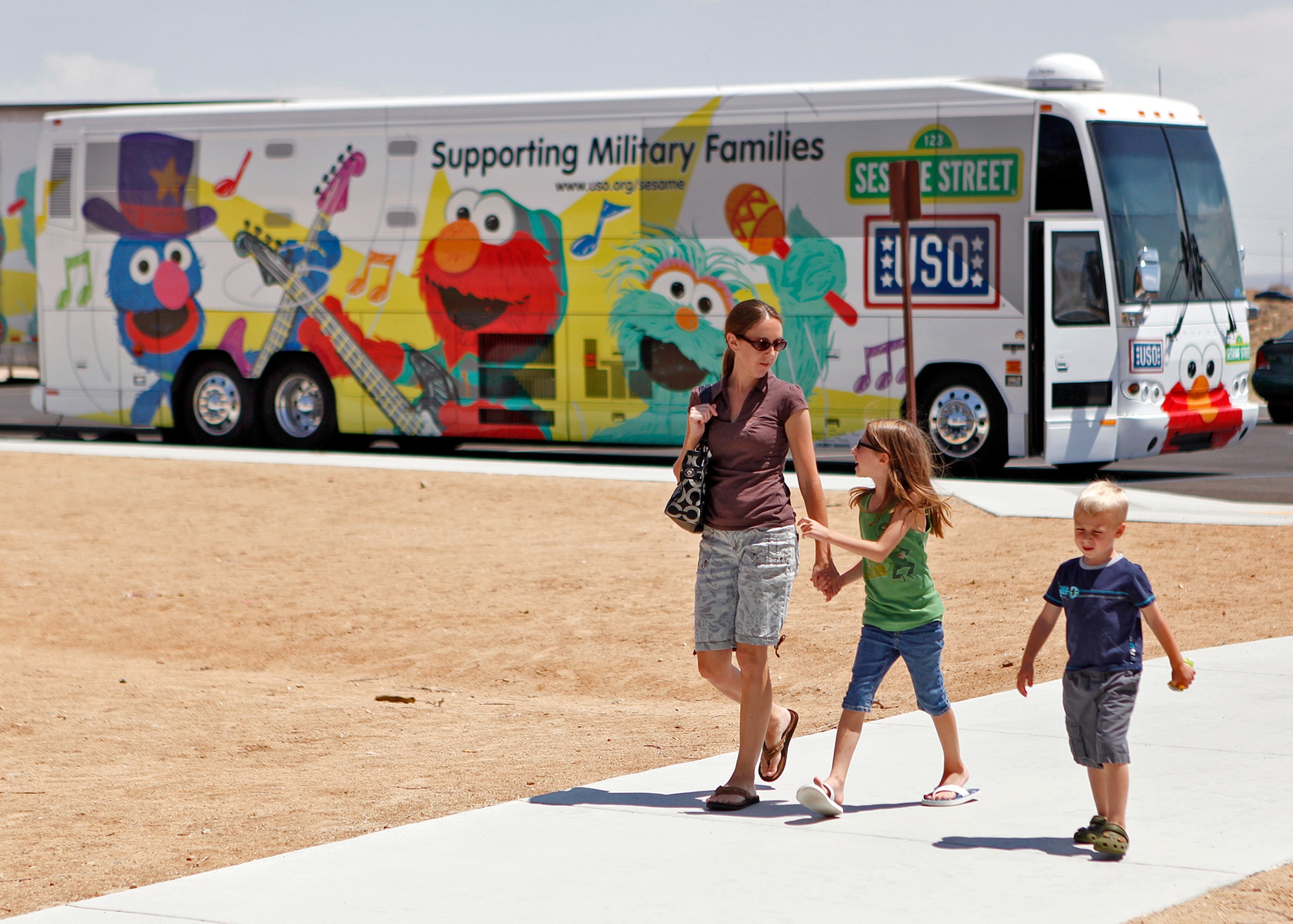 An Edwards family arriving at the Oasis Community Center for the USO Sesame Street show at Edwards Air Force Base, Calif., Aug. 10. (U.S. Air Force photo by Jet Fabara)