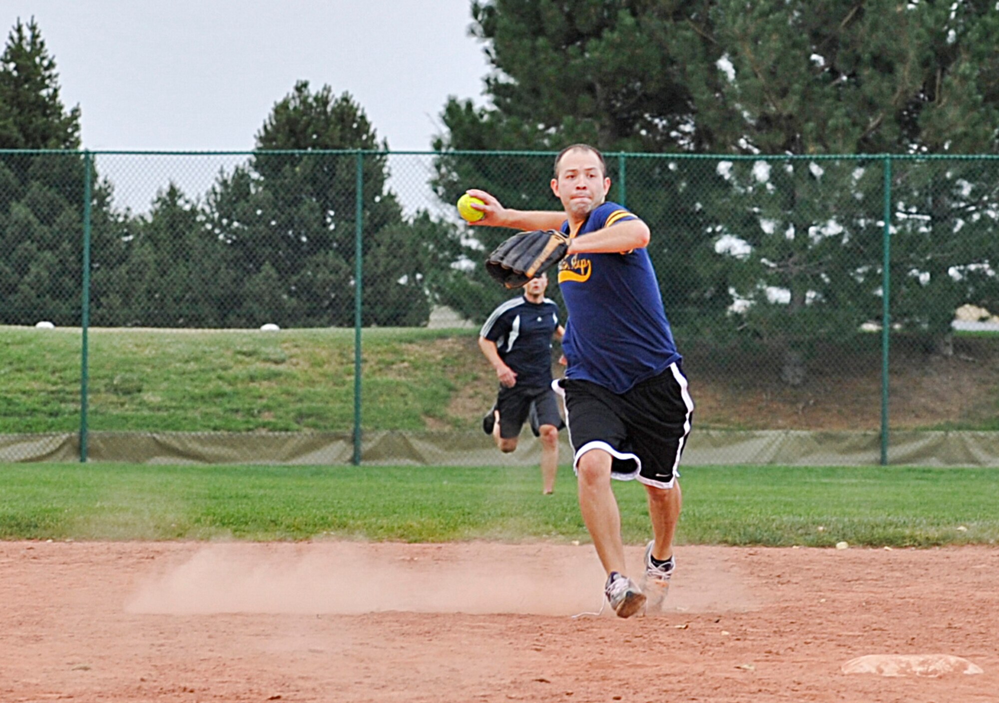 BUCKLEY AIR FORCE BASE, Colo. – Jason Loeza makes a throw to first base from shortstop during a game of intramural softball Aug. 9, 2012. Loeza is a petty officer first class playing shortstop for the Navy Operational Support Center, Denver. His team lost to the Marine Air Control Squadron with a score of 24-1. (U.S. Air Force photo by Senior Airman Christopher Gross)