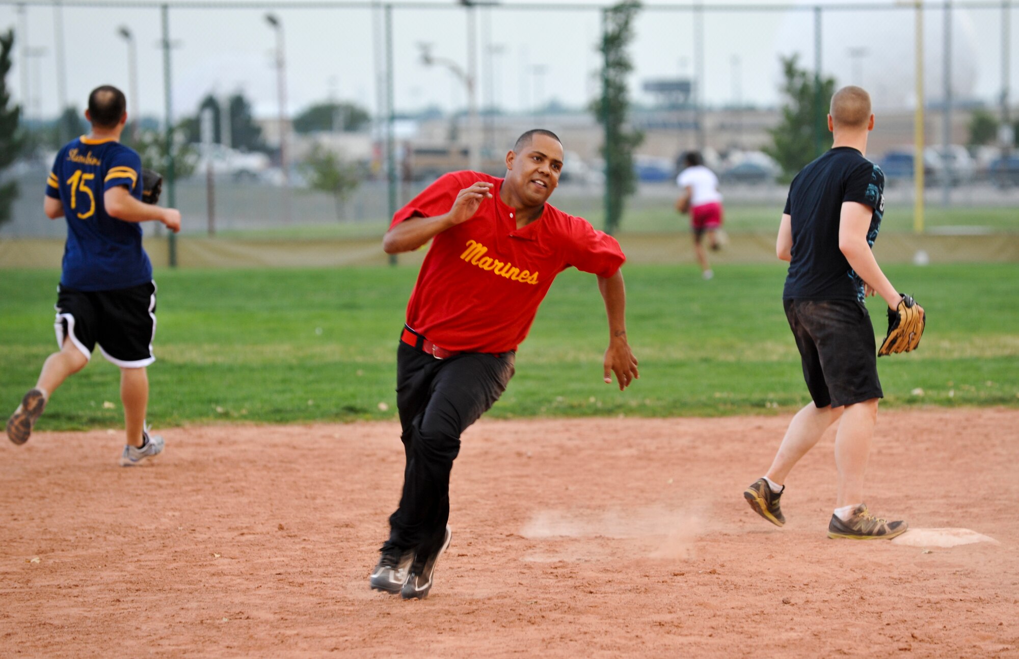BUCKLEY AIR FORCE BASE, Colo. – P. Dawson rounds second base during a game of intramural softball Aug. 9, 2012. Dawson is a lance corporal assigned to the Marine Air Control Squadron 23. MACS 23 beat the Navy Operational Support Center, Denver with a score of 24-1 and to add to their winning record of 11-1. (U.S. Air Force photo by Senior Airman Christopher Gross)