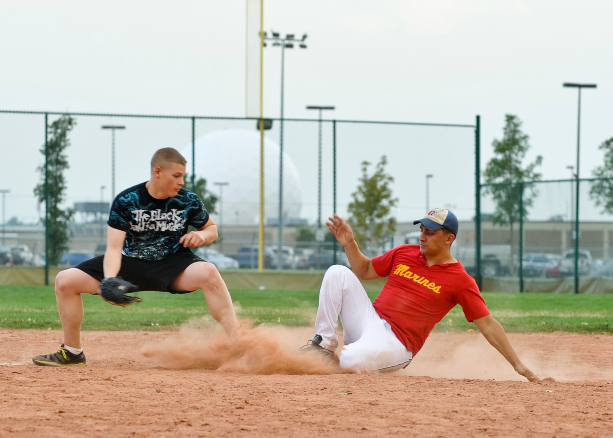BUCKLEY AIR FORCE BASE, Colo. – J.R. Huerta slides into second base during a game of intramural softball Aug. 9, 2012. Huerta is a lance corporal assigned to the Marine Air Control Squadron 23. MACS 23 beat the Navy Operational Support Center, Denver with a score of 24-1. (U.S. Air Force photo by Senior Airman Christopher Gross)