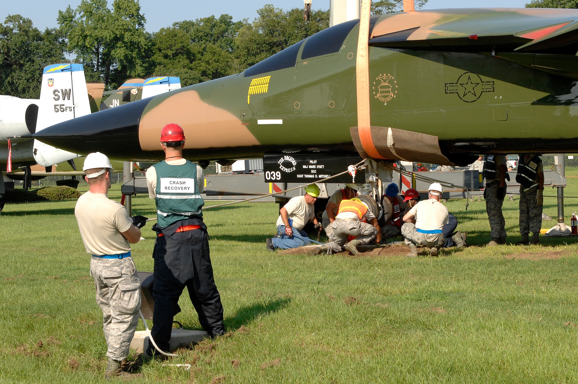 Staff Sgt. Nathan Kilgore, 20th Equipment Maintenance Squadron crash recovery, and Senior Airmen Jeremy Hargis assigned to 169th Fighter Wing at McEntire Joint National Guard Base use ropes to guide a F-111 Aardvark into place as it is mounted for display at Shaw Air Force Base, S.C., Aug. 13, 2012. The plane joined four other aircrafts on display at the front gate. (U.S. Air Force photo by Airman 1st Class Krystal M. Jeffers/Released)