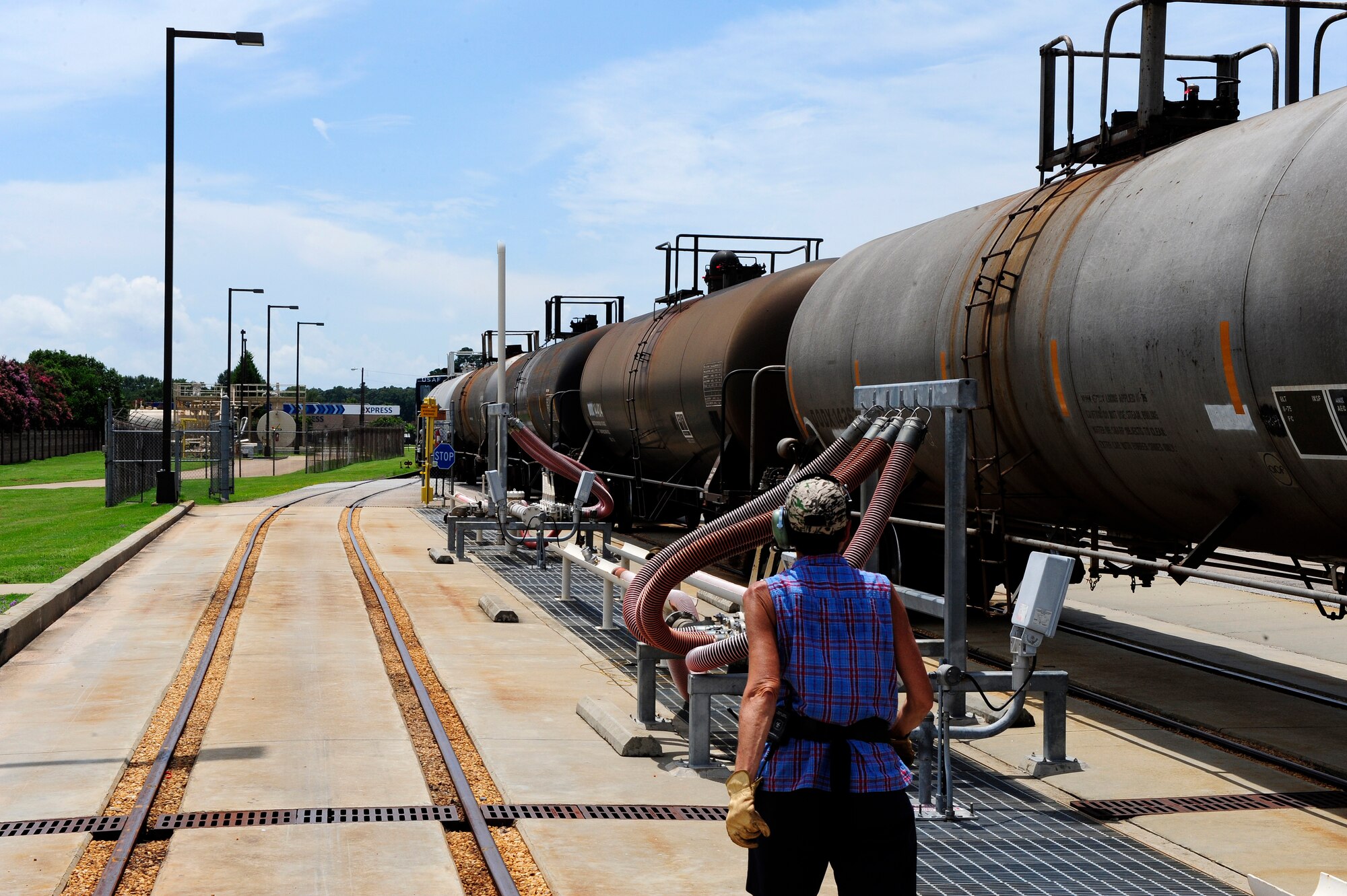 Michelle Hill, 20th Logistics Readiness Squadron D-Flight conductor/engineer, prepares to secure the tank cars within the fueling station, into position at Shaw Air Force Base, S.C., Aug. 09, 2012. Hill must manually secure the tank cars into position by rotating the hand brake located at the rear of each car, preventing it from moving while docked. (U.S. Air Force photo by Airman 1st Class Daniel Blackwell/Released)