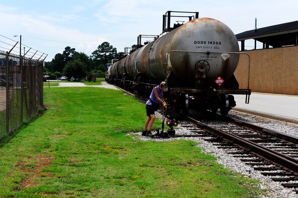 Michelle Hill, 20th Logistics Readiness Squadron D-Flight conductor/engineer, “throws the switch” as she changes the active track that the tank cars will be moved on at Shaw Air Force Base, S.C., Aug. 09, 2012. “Throwing the switch” plays a vital role in maneuvering the tank cars into the fueling station. (U.S. Air Force photo by Airman 1st Class Daniel Blackwell/Released)