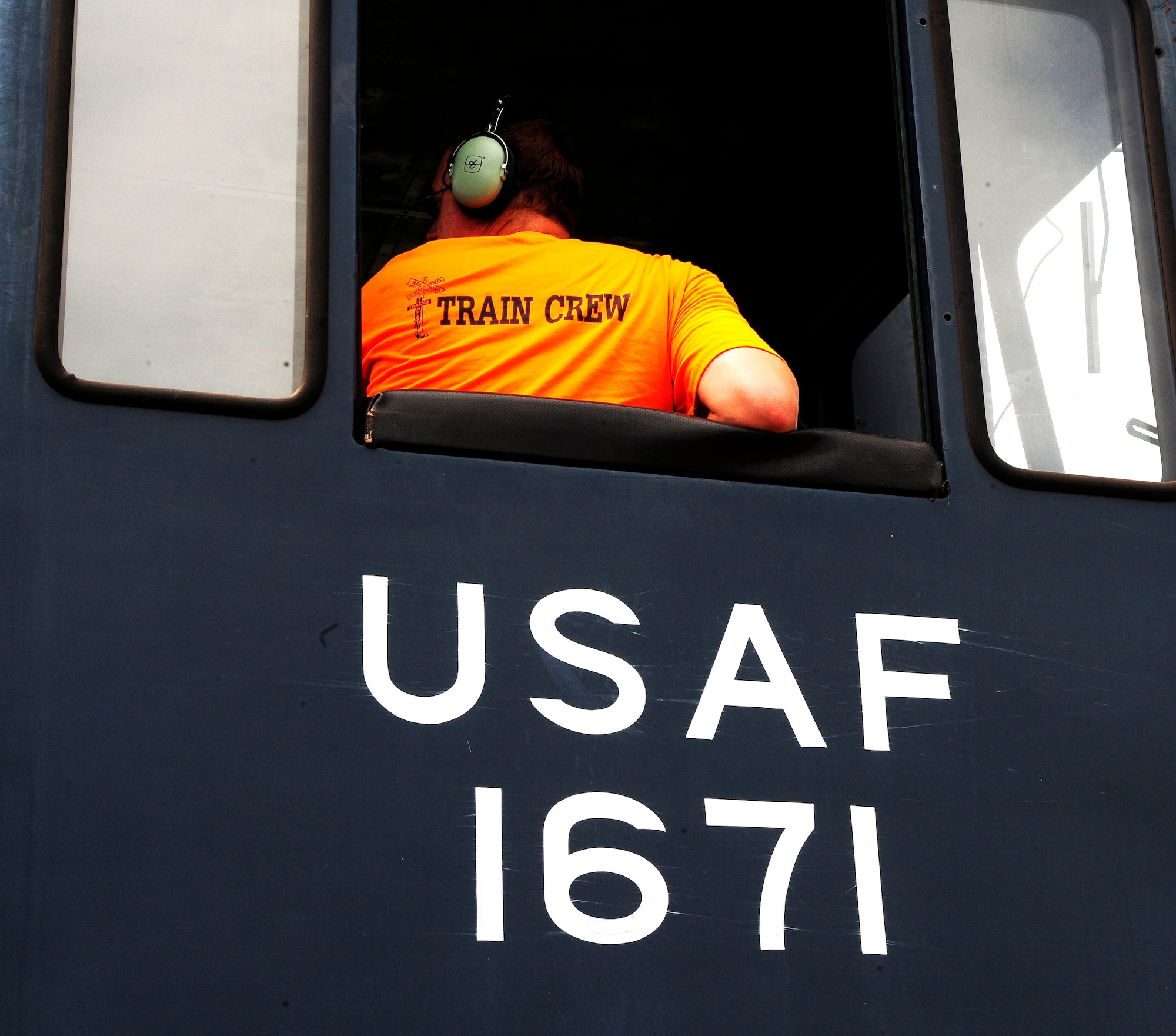 Adam McDowell, 20th Logistics Readiness Squadron D-Flight engineer/conductor, looks back as he prepares to navigate the locomotives into position to dock the remaining tank cars for fueling at Shaw Air Force Base, S.C., Aug. 09, 2012. The locomotives, which weigh 80 tons each, must be navigated carefully as not to damage equipment or injure personnel. (U.S. Air Force photo by Airman 1st Class Daniel Blackwell/Released)