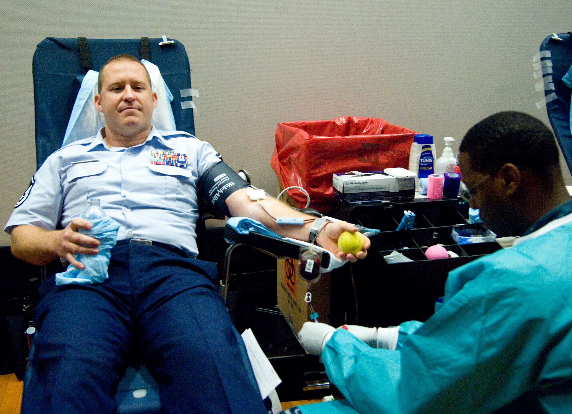 Master Sgt. Joseph Ross has blood drawn by hospital man Andres Rodriguez-Brown during a military-to-military blood drive Aug. 6, 2012, at Dover Air Force Base, Del. Team Dover donated more than 80 units of blood that were sent to service members downrange in approximately 24 hours. One unit of blood has the potential to save three lives. (U.S. Air Force photo by Adrian Rowan)