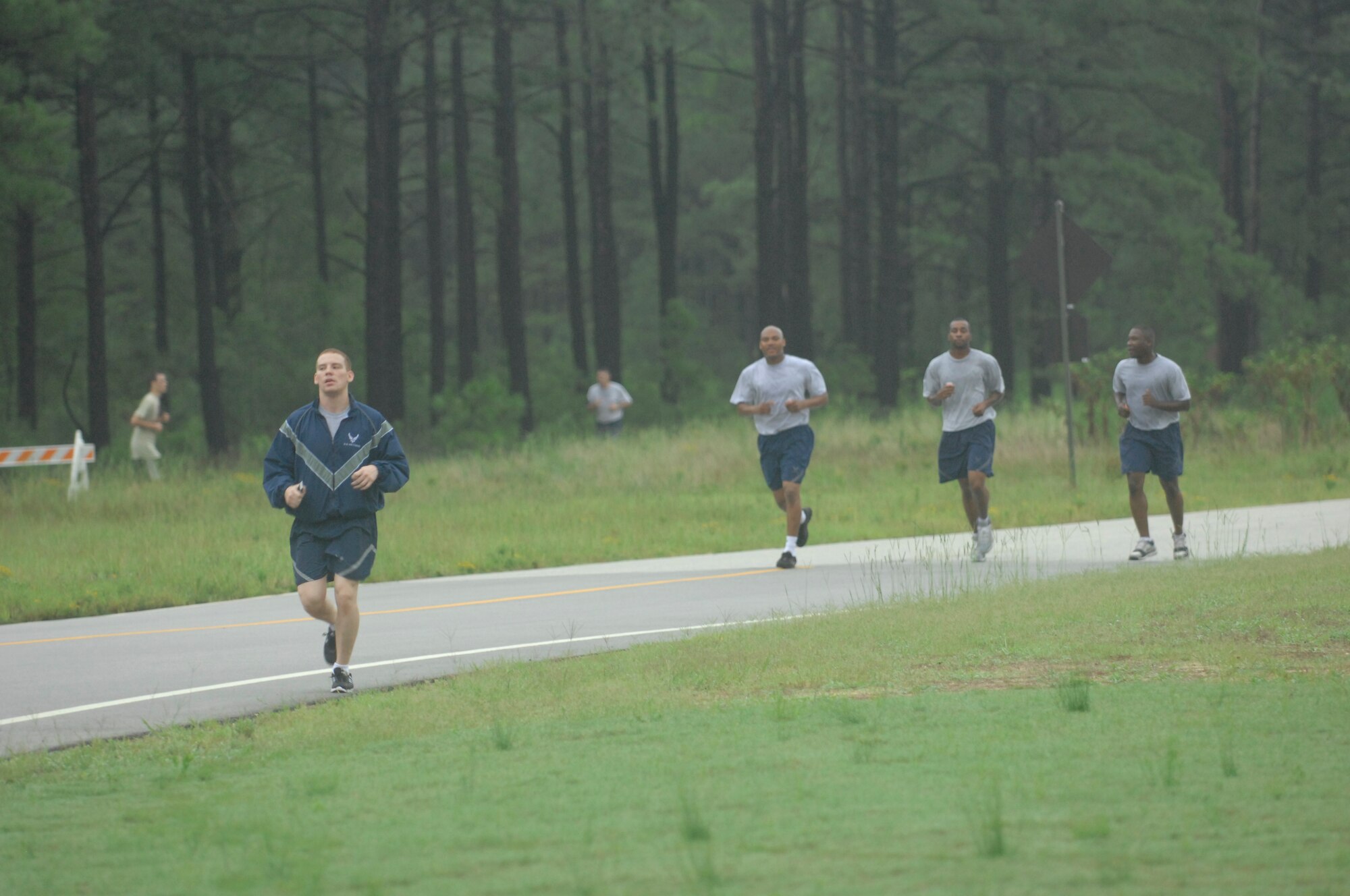 Airmen race towards the finish line during the 5k Poker Run at Shaw Air Force Base, S.C., Aug. 10, 2012. During the race the participants had to gather five cards spread across 3 ? miles and the person with the best hand at the end won a prize. The fastest runner crossed the finish line at about 16 minutes though the race continued until the last person crossed at about 30 minutes. (U.S. Air Force photo by Airman 1st Class Krystal M. Jeffers/Released)