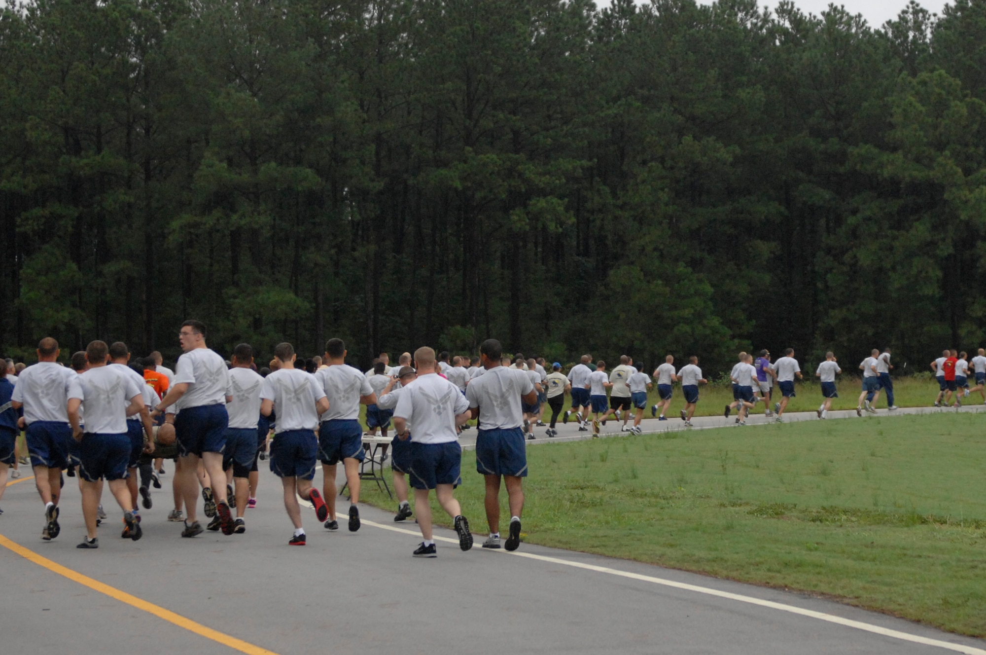 Airmen race through Shaw Air Force Base, S.C., during a 5K Poker Run Aug. 10, 2012. The race began after morning reveille and had participants collect five cards which were then used afterwards to win prizes. (U.S. Air Force photo by Airman 1st Class Krystal M. Jeffers/Released)