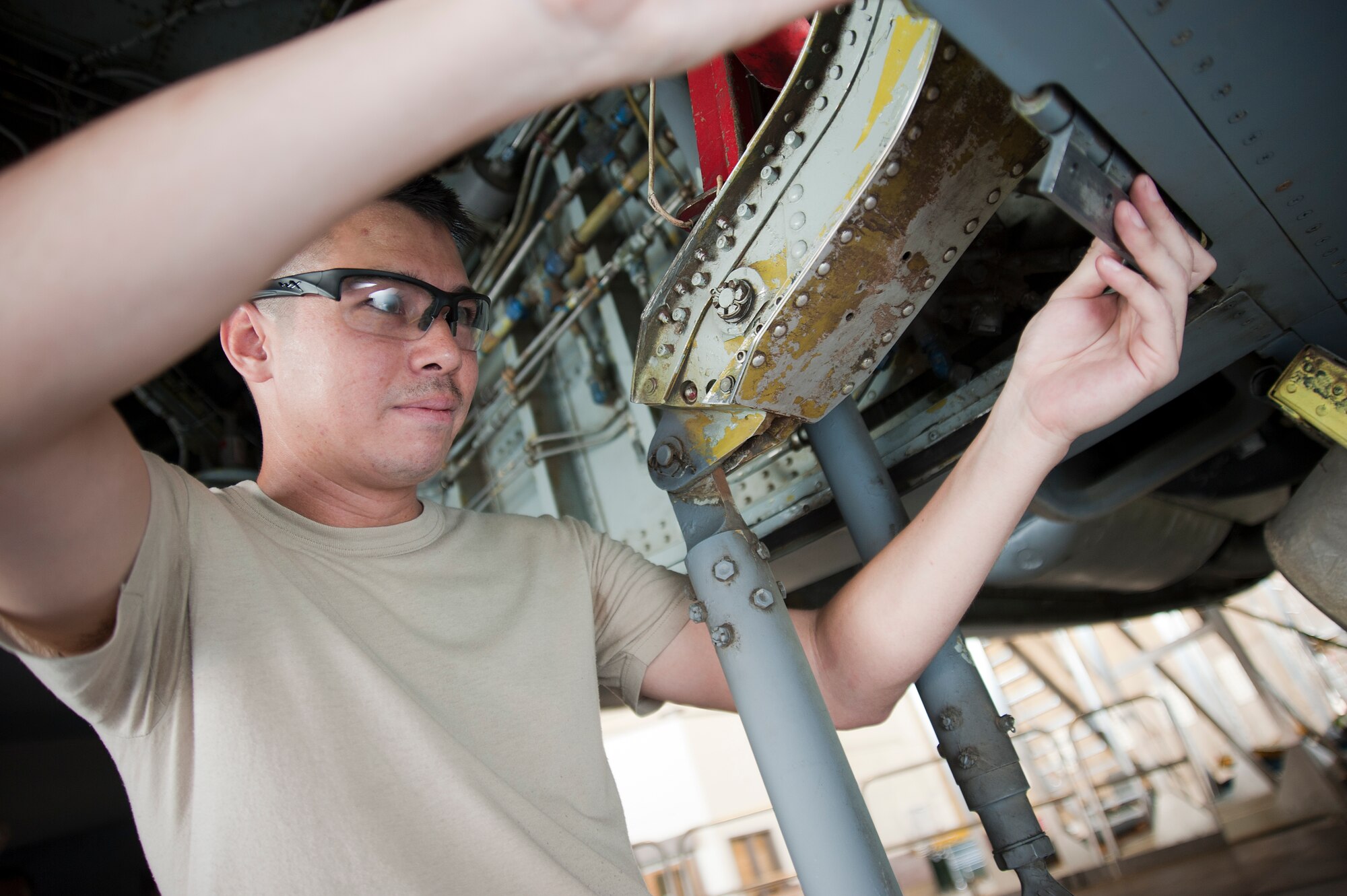 Staff Sgt. Thomas Pham, 22nd Maintenance Squadron inspection section journeyman, works on a KC 135 Stratotanker landing gear door mount Aug. 13, 2012, McConnell Air Force Base, Kan. Pham was named the spotlight performer for the week of Aug. 13 to 17, 2012. (U.S. Air Force photo/ Airman 1st Class Jose Leon)