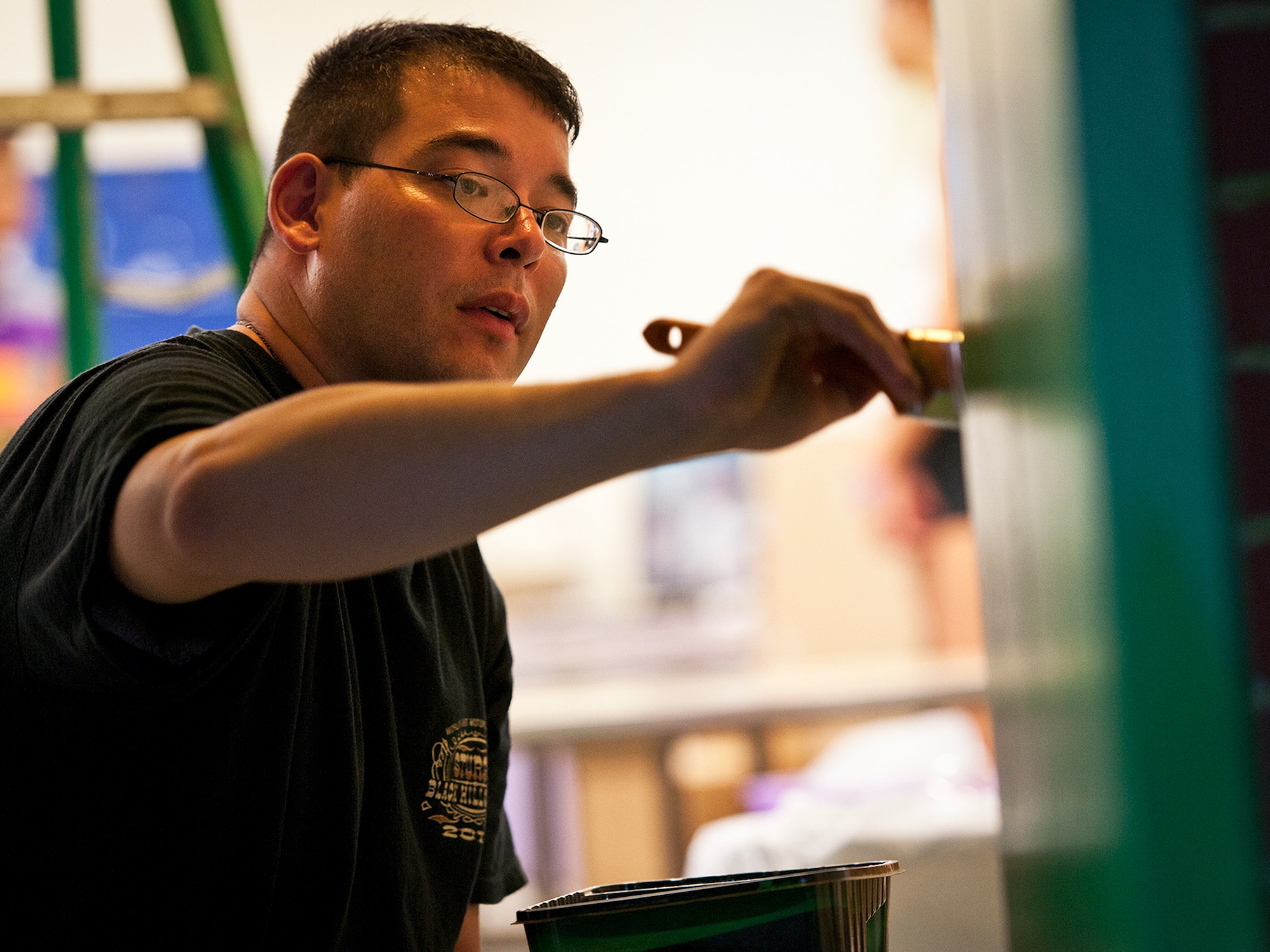 Tech. Sgt. Austin Hetland, of the 33rd Maintenance Squadron paints along the inside of a door of a classroom at Kenwood Elementary School in Fort Walton Beach, Fla., Aug. 14.  Members of the 33rd MXS and the 33rd Maintenance Group’s quality assurance team spent three days cleaning and painting before the kids return Aug.  20.  (U.S. Air Force photo/Samuel King Jr.)