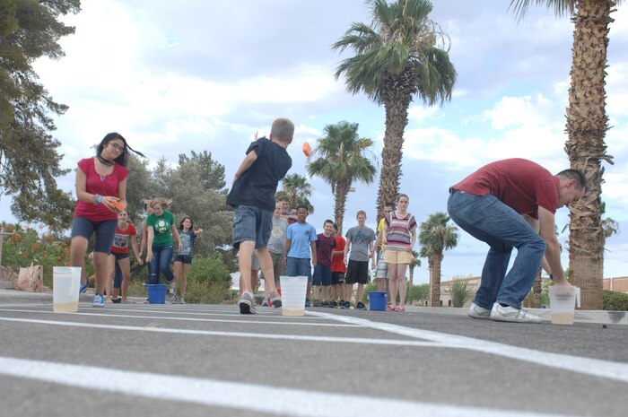 Club Beyond participants fill pitchers with water during a water war relay event held at the Nellis Air Force Base chapel, Aug. 9, 2012. The water war relay was one of many games held during the Club Beyond Olympics which was designed to further teamwork and friendships between the youth that come to Club Beyond. (U.S. Air Force photo by Master Sgt. David Miller)