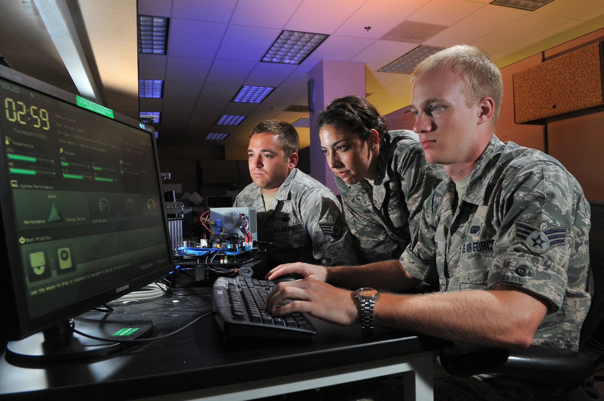 2nd Lt. Stephanie Stanford, 90th Information Operations Squadron cyber development lead, Staff Sgt. Aaron Wendel, 90th IOS cyber network technician, and Senior Airman Brett Tucker, 90th IOS cyber systems operator, perform cyber operations Aug. 1 at Lackland Air Force Base, Texas. (U.S. Air Force photo by Boyd Belcher)