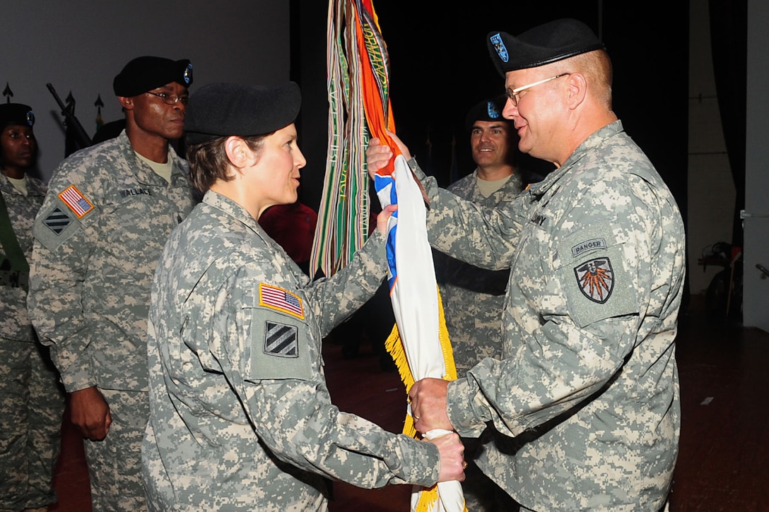 U.S. Army Col. John B. Hildebrand, commander of the 7th Signal Command, passes the guidon to Col. Maria A. Biank, incoming 93rd Signal Brigade commander, at a change of command ceremony at Fort Eustis, Va., Aug. 13, 2012. Traditionally, passing the guidon from one leader to another represents the passing of trust and well being of the unit. (U.S. Air Force photo by Staff Sgt. Ashley Hawkins/Released)