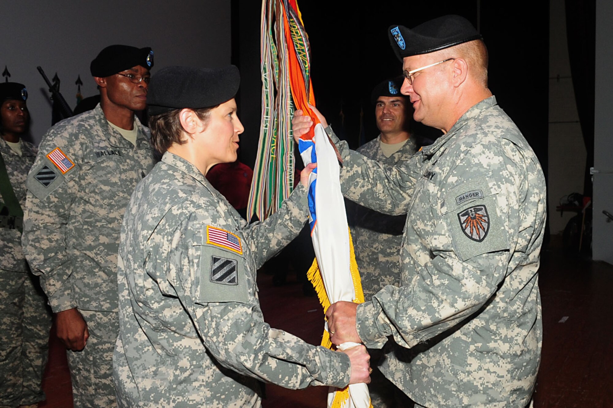 U.S. Army Col. John B. Hildebrand, commander of the 7th Signal Command, passes the guidon to Col. Maria A. Biank, incoming 93rd Signal Brigade commander, at a change of command ceremony at Fort Eustis, Va., Aug. 13, 2012. Traditionally, passing the guidon from one leader to another represents the passing of trust and well being of the unit. (U.S. Air Force photo by Staff Sgt. Ashley Hawkins/Released)