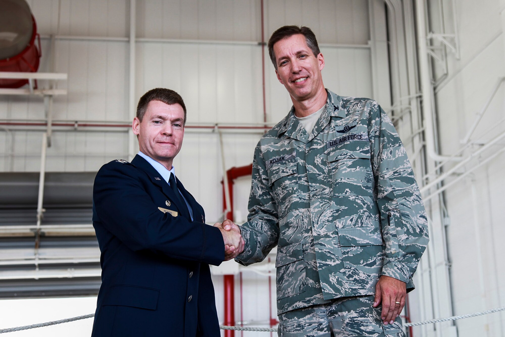 Col. Craig Peters, 911th Airlift Wing commander, formally introduces and welcomes the new Vice Commander, Col. Jeffrey Kozak, during the Wing’s commander’s call held at hangar 129, Aug. 9, 2012. Col. Kozak’s main responsibility is to assist the commander in maintaining the combat capabilities of the 911th Airlift Wing and the mission to support the C-130H2 aircraft. Prior to his current position, Colonel Kozak was an action officer for the Commander of the Air Force Reserve Command in the Commanders Action Group.  (U.S. Air Force photo by Ralph Van Houtem/Released)