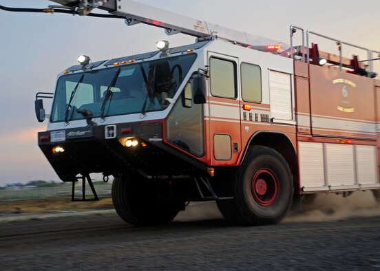 Fairchild firefighters operate Crash 6 to the next objective during simulated live-fire training at Fairchild Air Force Base, Wash., July 10, 2012. The Fire Department is able to simulate various aircraft and fuel spill fires. (U.S. Air Force photo/Airman 1st Class Ryan Zeski) 
