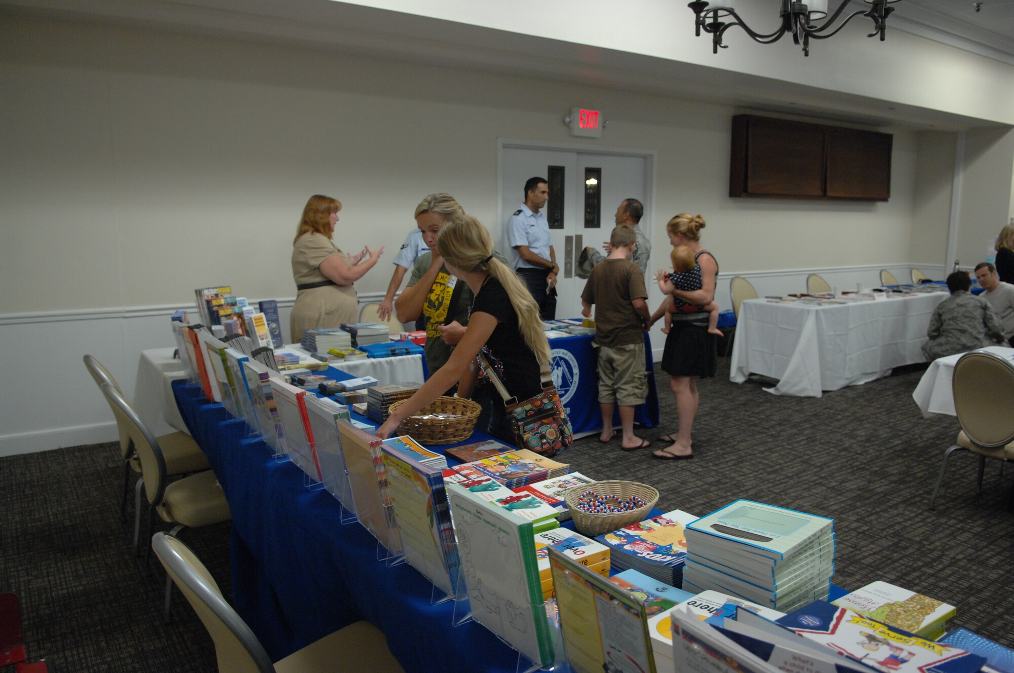 Spouses of deployed military members check out brochures put out by agencies and offices from Shaw Air Force Base (AFB) and the Sumter community, during the Deployed Spouses Dinner at Carolina Skies Club, Aug. 13.  More than 200 attended this event sponsored by chapel services. (U.S. Air Force Photo by Staff Sgt. Ave I. Young/Released)