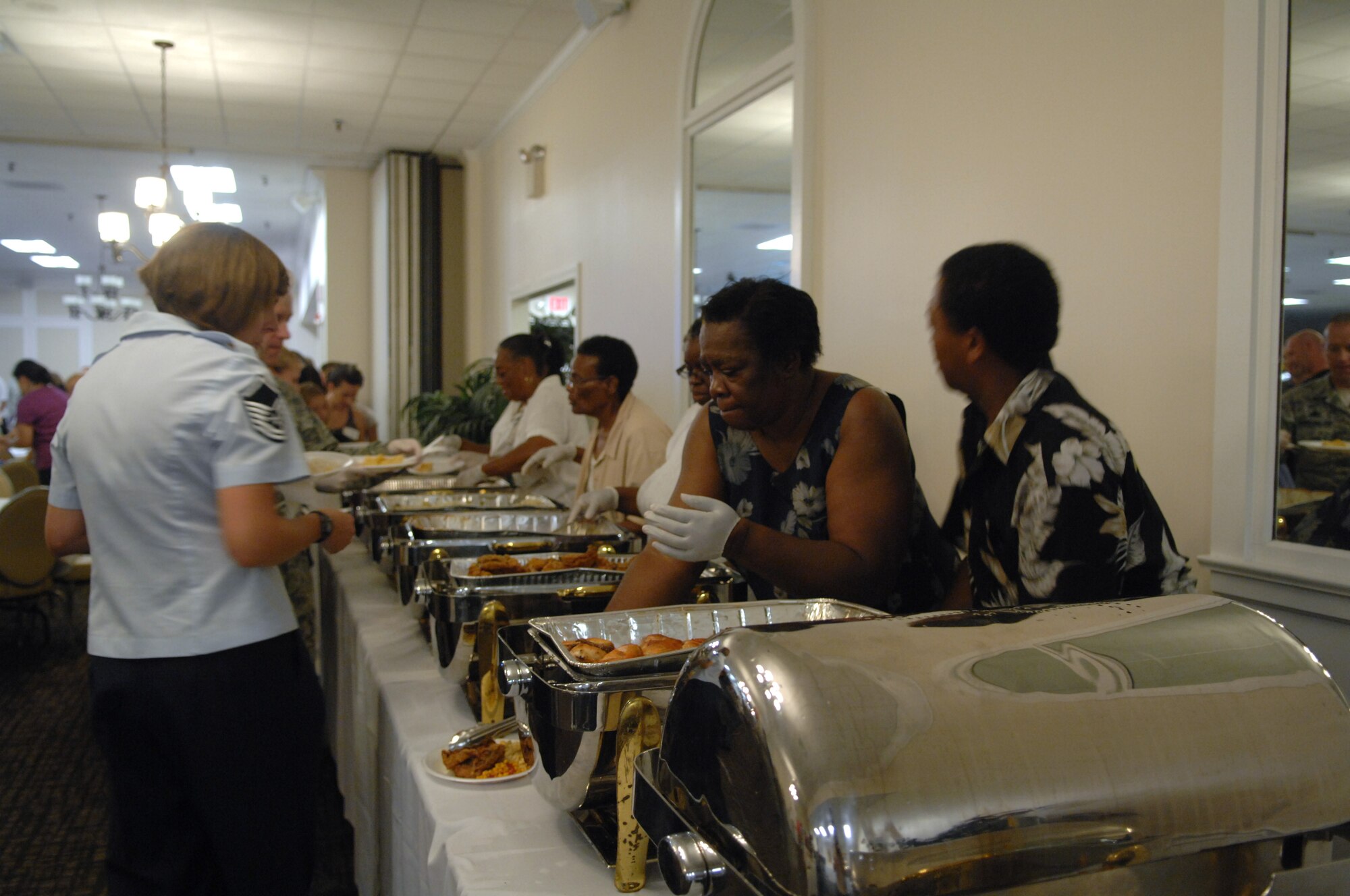 Members of the Reid Chapel African Methodist Episcopal Church, serve dinner that they prepared and provided for the Deployed Spouses Dinner held at Carolina Skies Club, Shaw Air Force Base, S.C., Aug. 13.  More than 200 attended this event sponsored by chapel services. (U.S. Air Force Photo by Staff Sgt. Ave I. Young/Released)