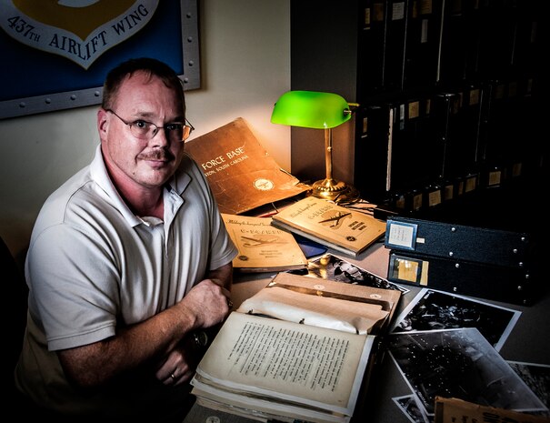 Stan Gohl, 437th Airlift Wing historian, looks through historical documents at Joint Base Charleston - Air Base, S.C. Gohl has been assigned to JB Charleston - Air Base for five years as a civilian and is a retired Air Force master sergeant. (U.S. Air Force photo / Airman 1st Class Tom Brading)