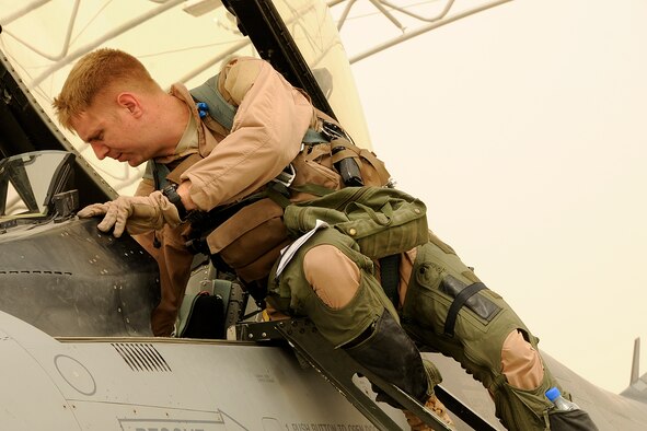 South Carolina Air National Guard Maj. Ian "Chester" Toogood, an F-16 pilot, climbs out of his jet after returning from a mission over Afghanistan on Aug. 5, 2012. Members of the 169th Fighter Wing at McEntire Joint National Guard Base, S.C., are deployed to KAF in support of Operation Enduring Freedom. Swamp Fox F-16's, pilots, and support personnel began their Air Expeditionary Force deployment early April to take over flying missions for the air tasking order and provide close air support for troops on the ground in Afghanistan. (U.S. Air Force photo/Tech. Sgt. Stephen Hudson)